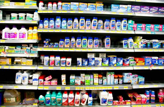 We offer a variety of OTC pills and supplements Pharmacy shelves lined with OTC products